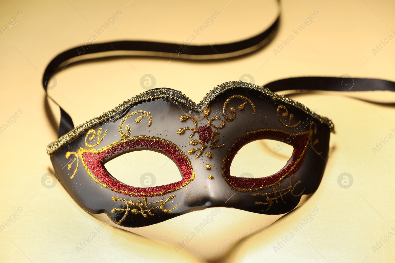 Photo of Elegant face mask on beige background. Theatrical performance