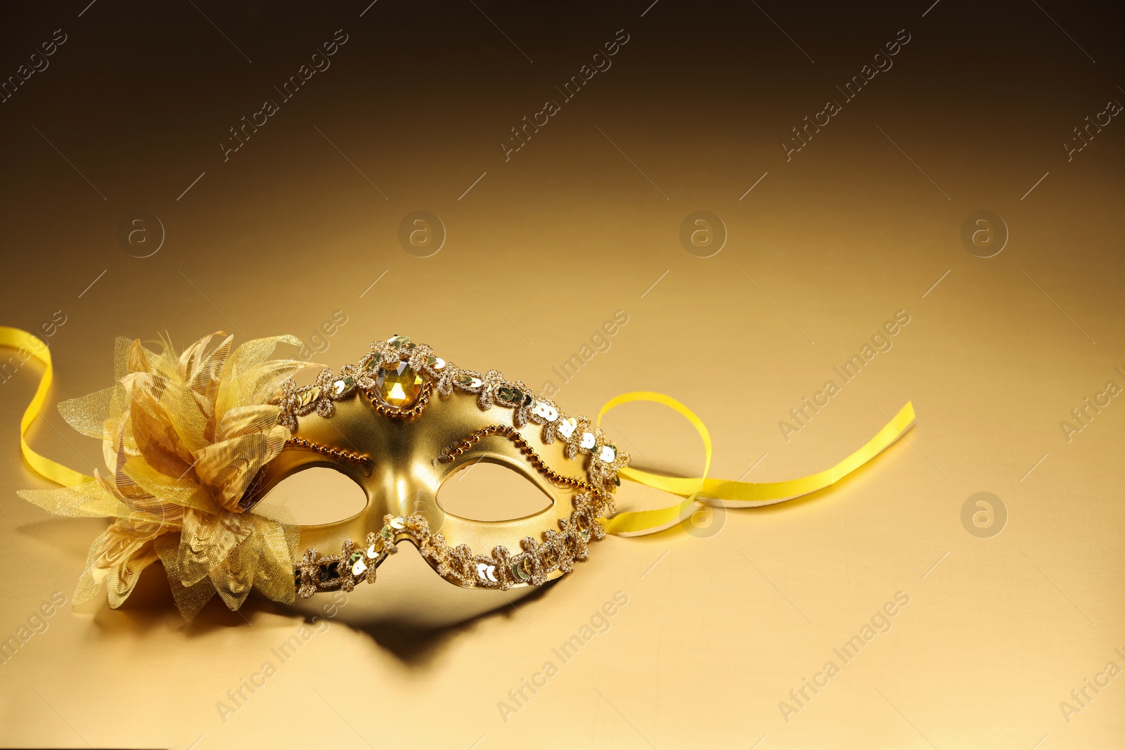 Photo of Beautifully decorated face mask on beige background, space for text. Theatrical performance