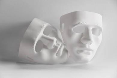 Photo of Plastic face masks on white background. Theatrical performance