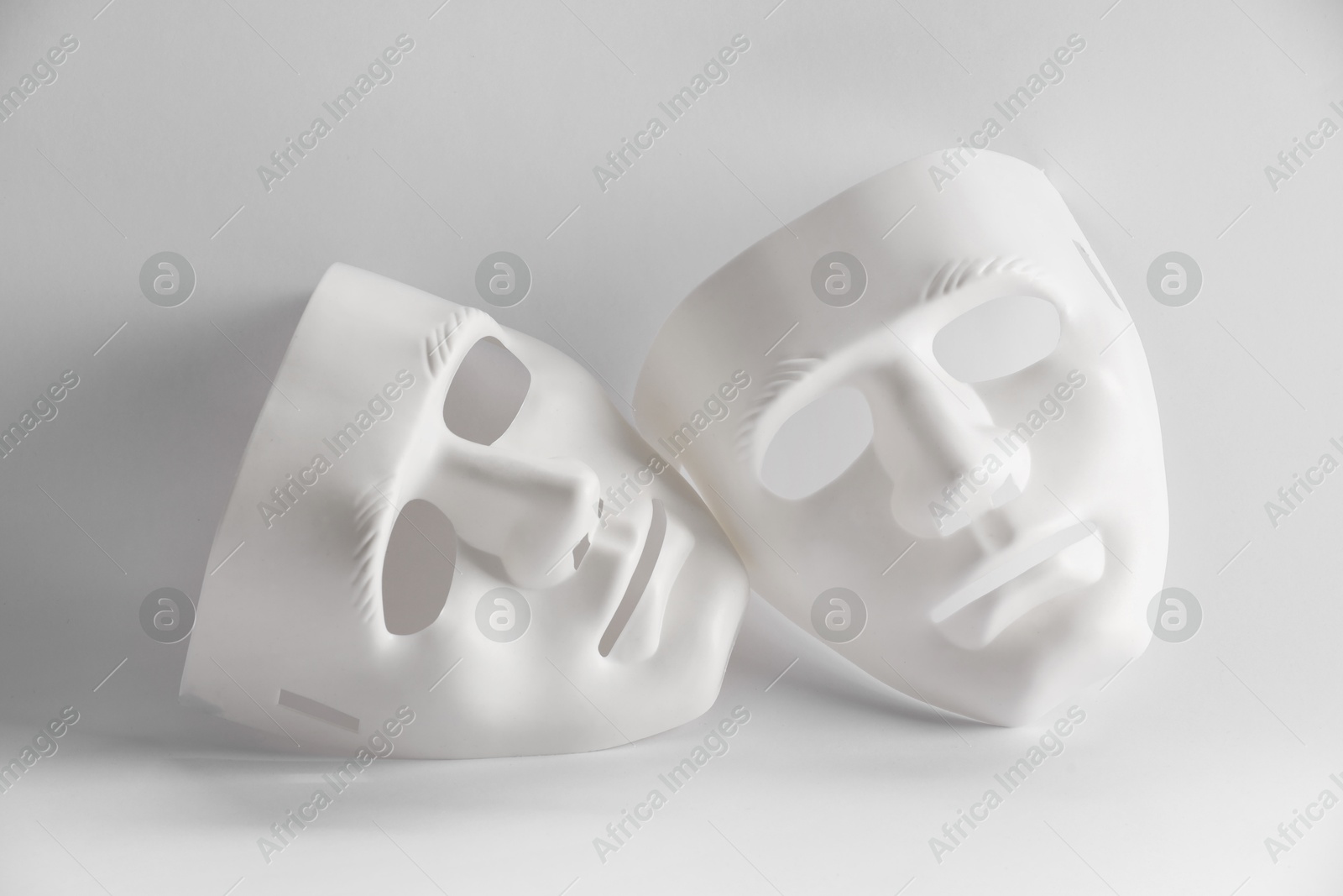 Photo of Plastic face masks on white background. Theatrical performance