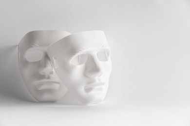 Plastic face masks on white background, space for text. Theatrical performance