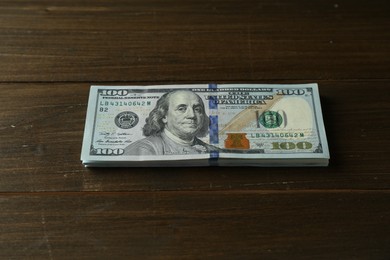 Stack of dollar banknotes on wooden table