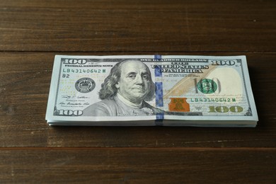 Stack of dollar banknotes on wooden table