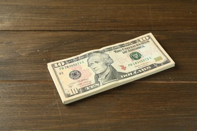 Stack of dollar banknotes on wooden table