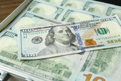 Photo of Case full of dollar banknotes on table, closeup