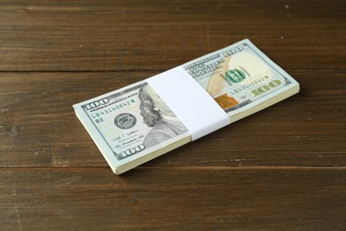 Bundle of dollar banknotes on wooden table