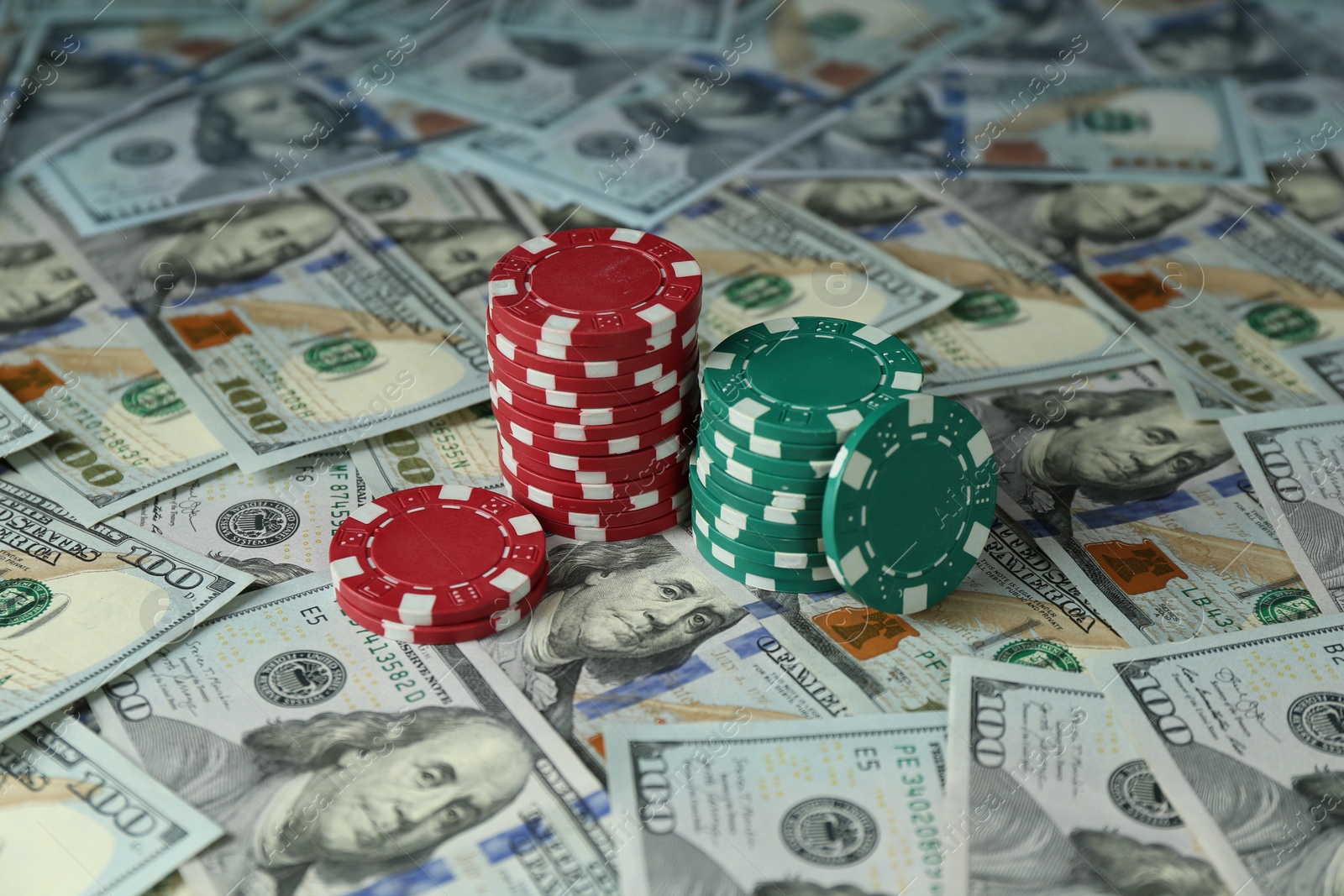 Photo of Stacks of casino chips on dollar banknotes