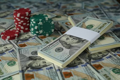 Many dollar banknotes and casino chips, closeup