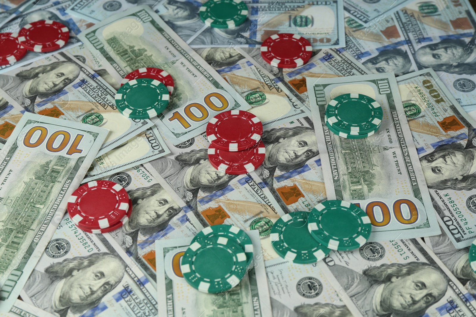 Photo of Many dollar banknotes and casino chips as background, closeup