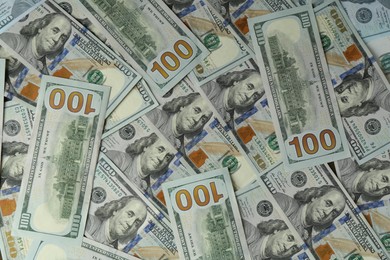 Photo of Many dollar banknotes as background, top view