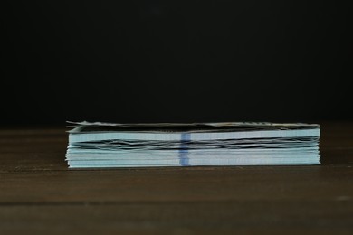 Stack of dollar banknotes on wooden table