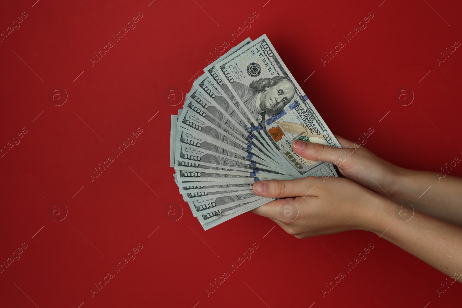 Photo of Woman with dollar banknotes on red background, closeup. Space for text