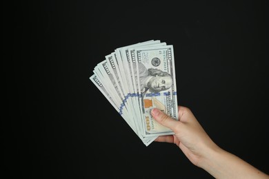 Photo of Woman with dollar banknotes on black background, closeup