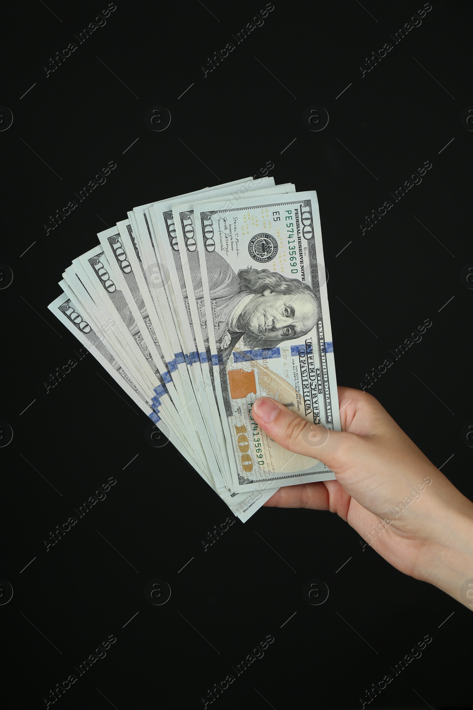 Photo of Woman with dollar banknotes on black background, closeup