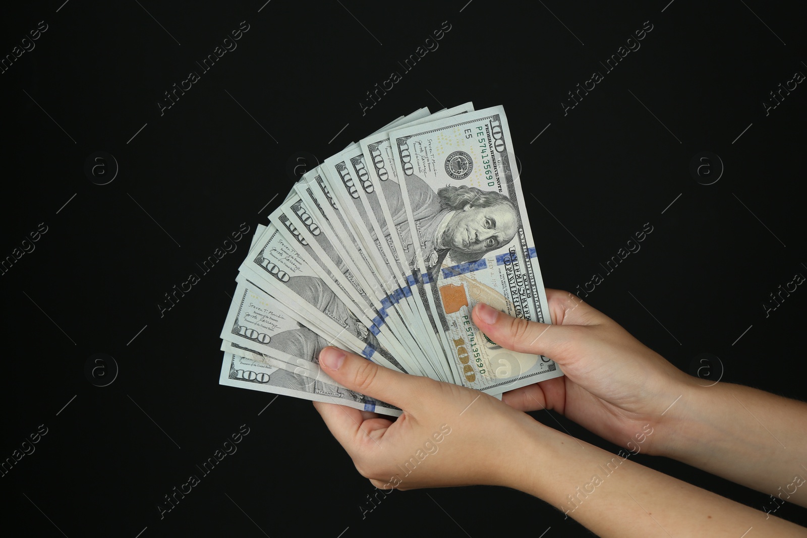 Photo of Woman with dollar banknotes on black background, closeup