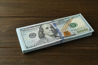 Stack of dollar banknotes on wooden table