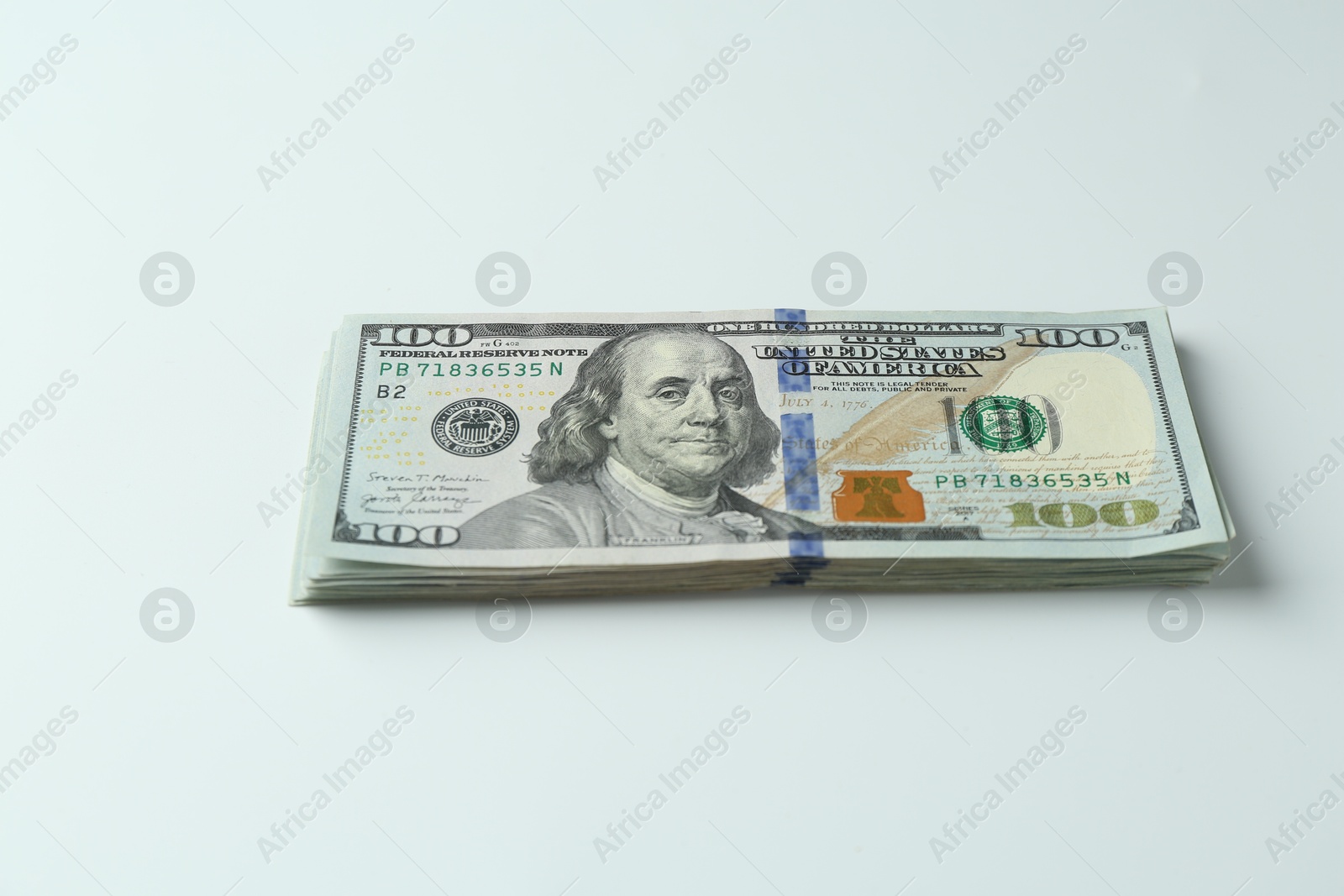 Photo of Stack of dollar banknotes on white background