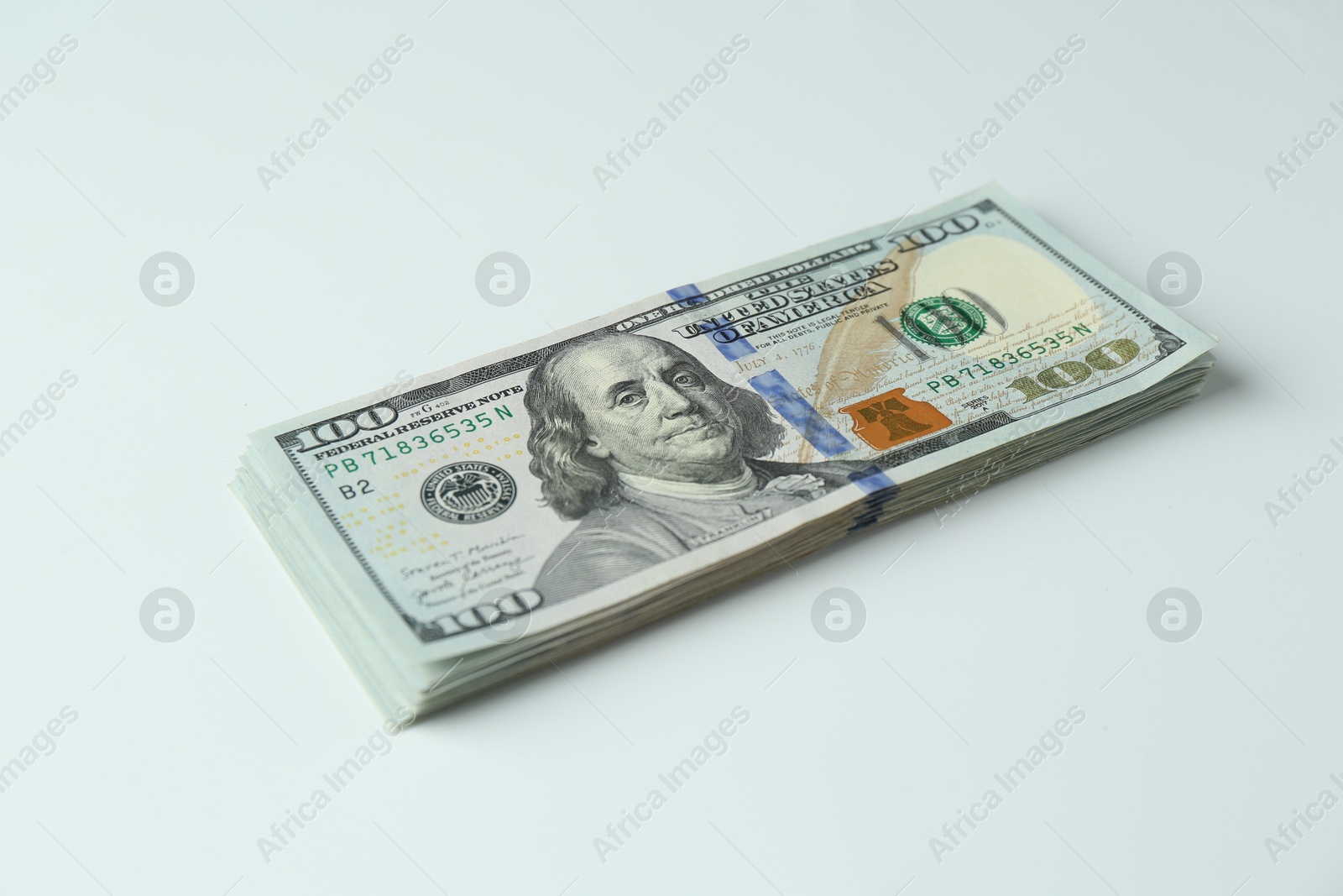 Photo of Stack of dollar banknotes on white background