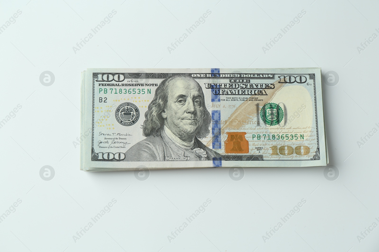 Photo of Stack of dollar banknotes on white background, top view