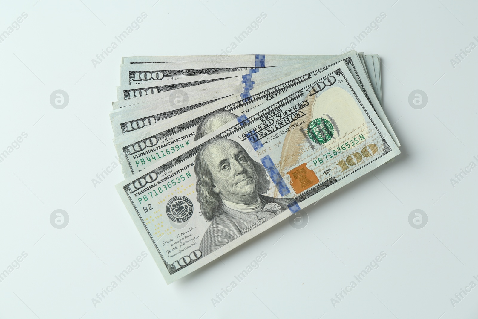 Photo of Many dollar banknotes on white background, top view