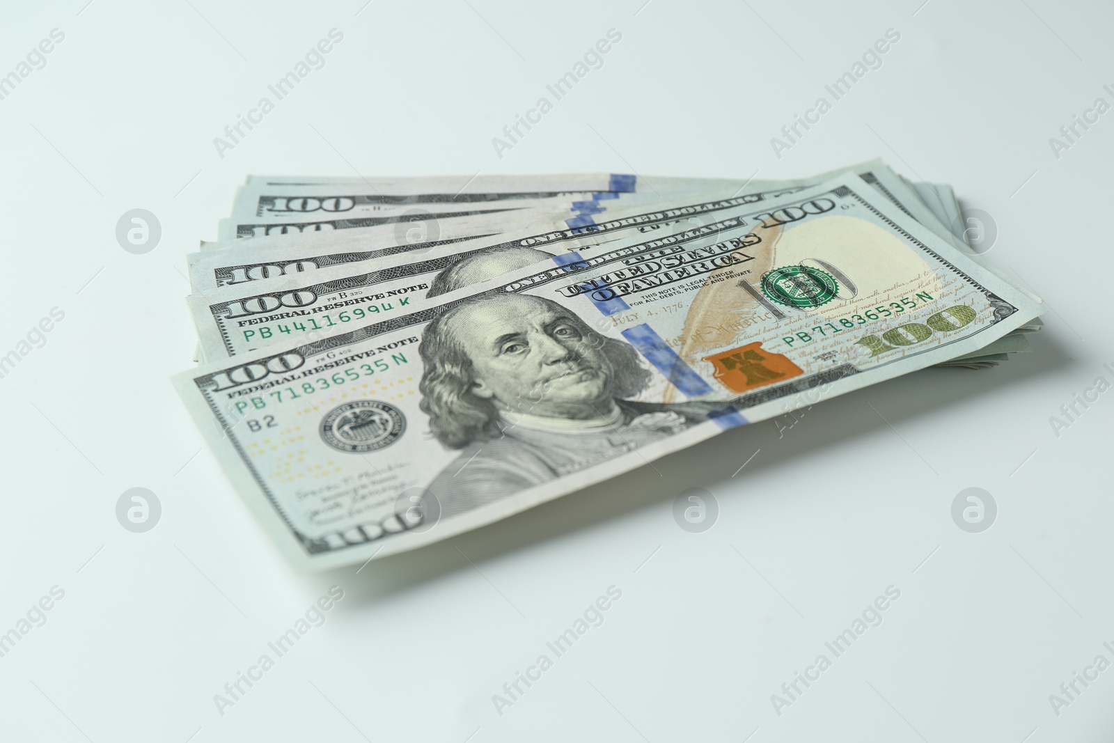 Photo of Many dollar banknotes on white background. American currency