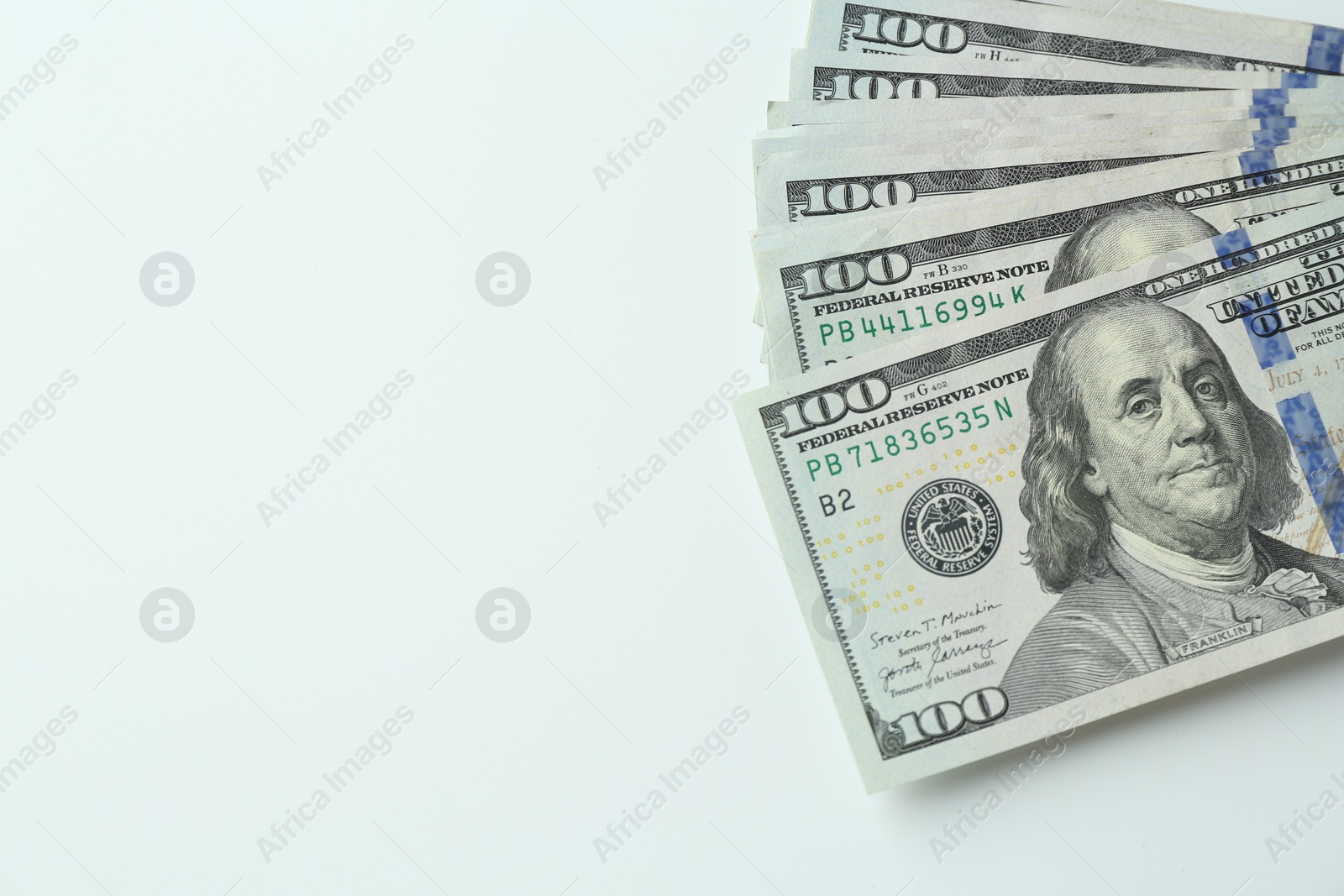 Photo of Many dollar banknotes on white background, top view. Space for text