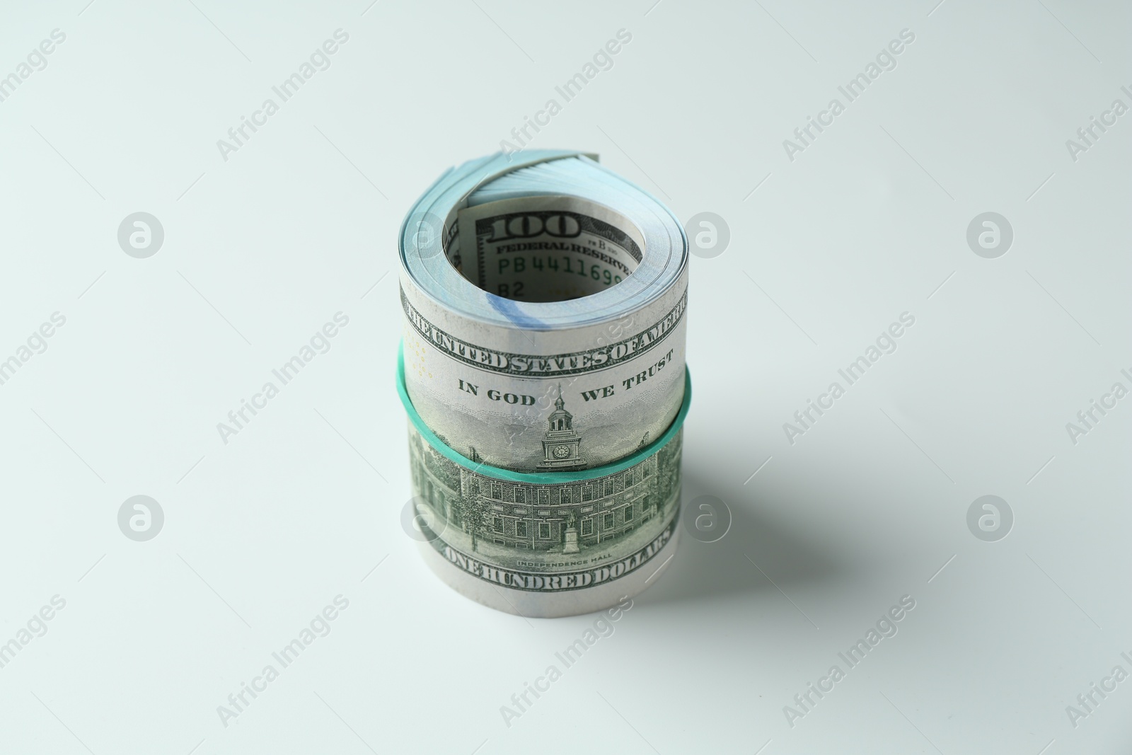 Photo of Roll of dollar banknotes on white background