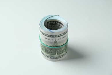 Roll of dollar banknotes on white background