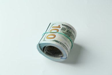 Roll of dollar banknotes on white background