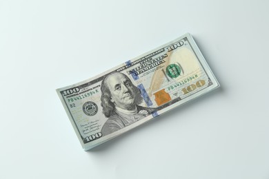 Photo of Stack of dollar banknotes on white background, top view