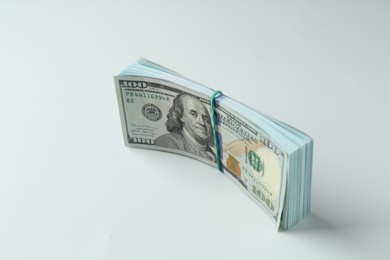 Photo of Bundle of dollar banknotes on white background