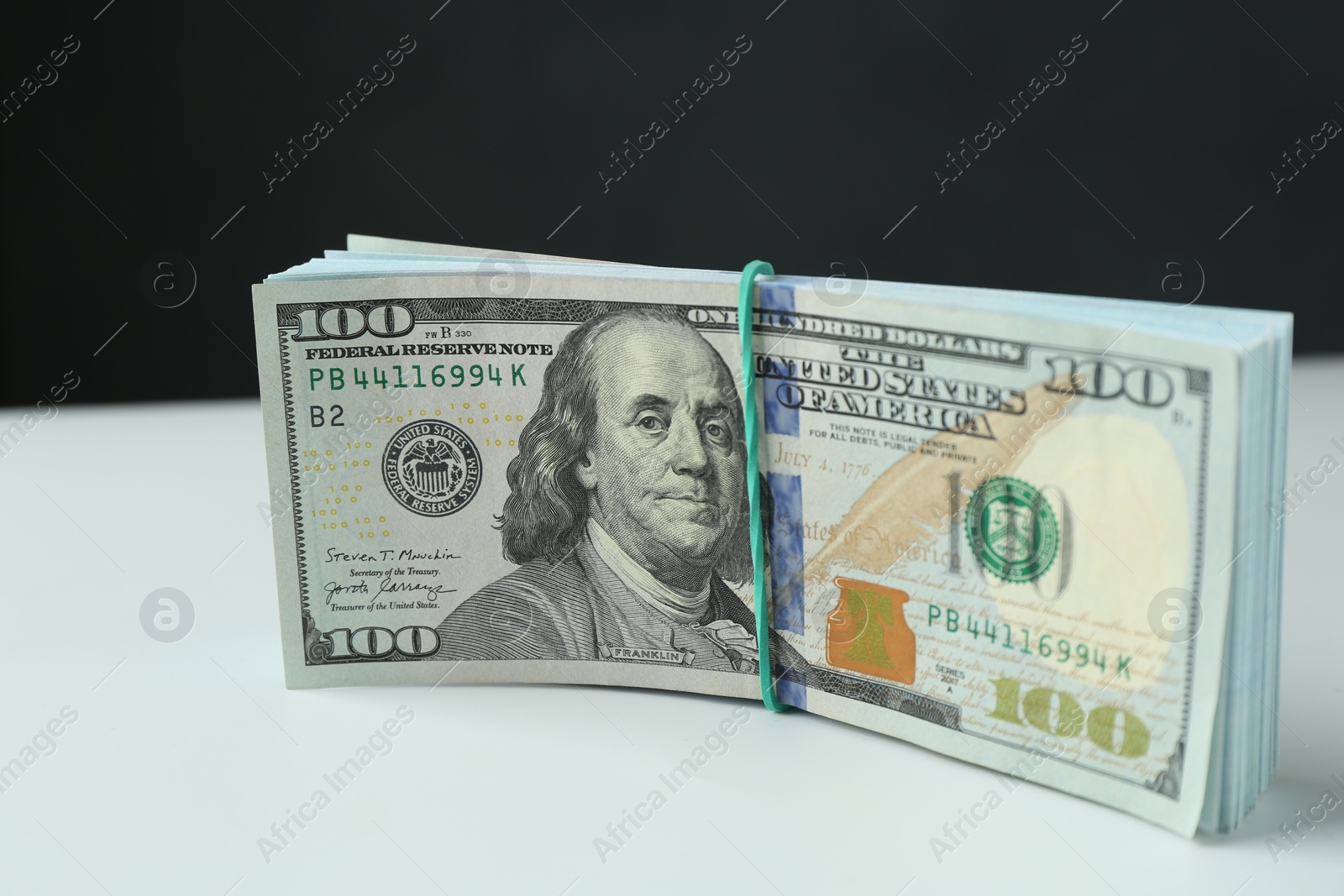 Photo of Bundle of dollar banknotes on white background