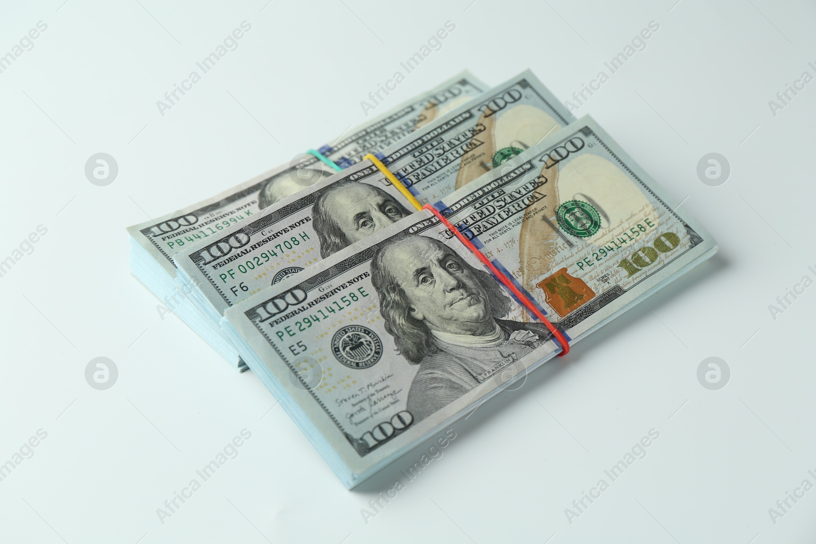 Photo of Bundles of dollar banknotes on white background