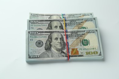 Photo of Bundles of dollar banknotes on white background