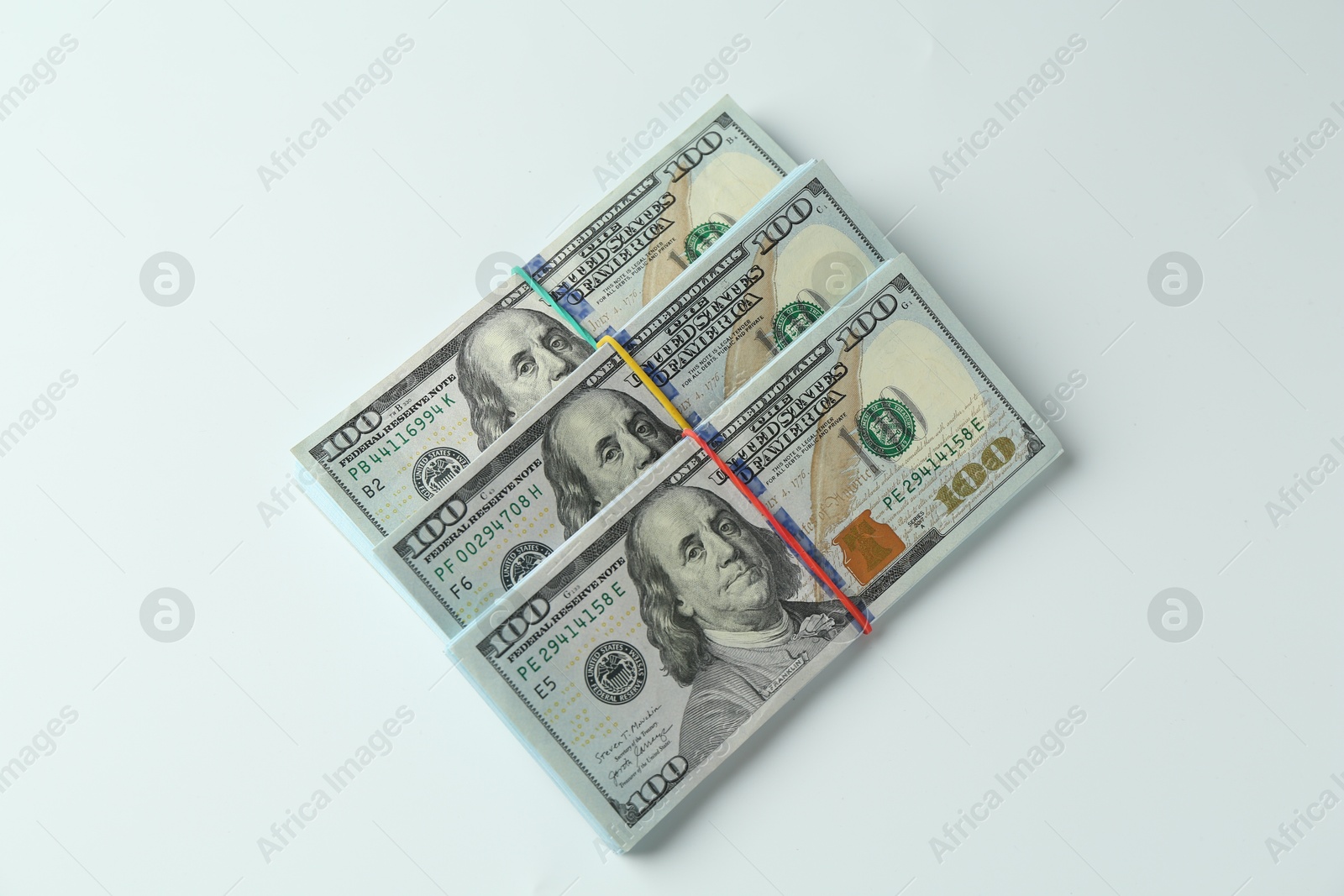 Photo of Bundles of dollar banknotes on white background, top view