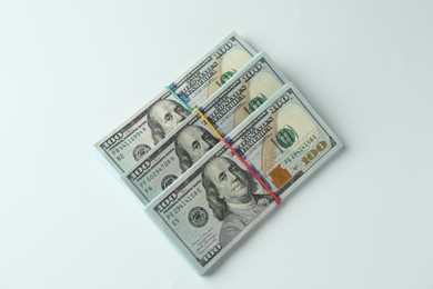 Photo of Bundles of dollar banknotes on white background, top view