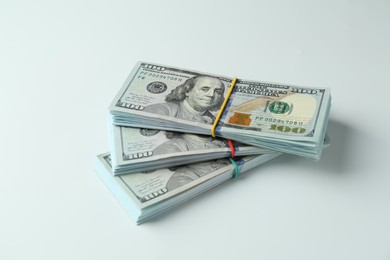 Photo of Bundles of dollar banknotes on white background