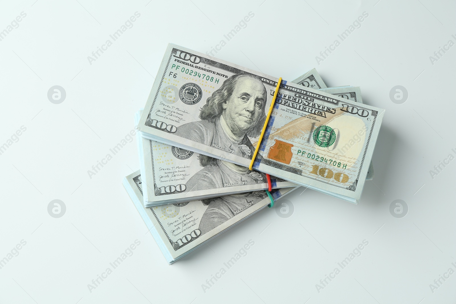 Photo of Bundles of dollar banknotes on white background, top view