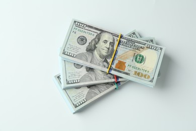 Photo of Bundles of dollar banknotes on white background, top view