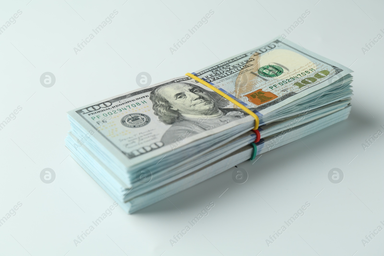 Photo of Bundles of dollar banknotes on white background, closeup