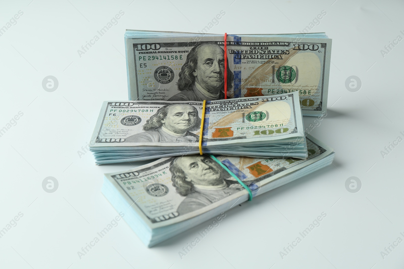 Photo of Bundles of dollar banknotes on white background