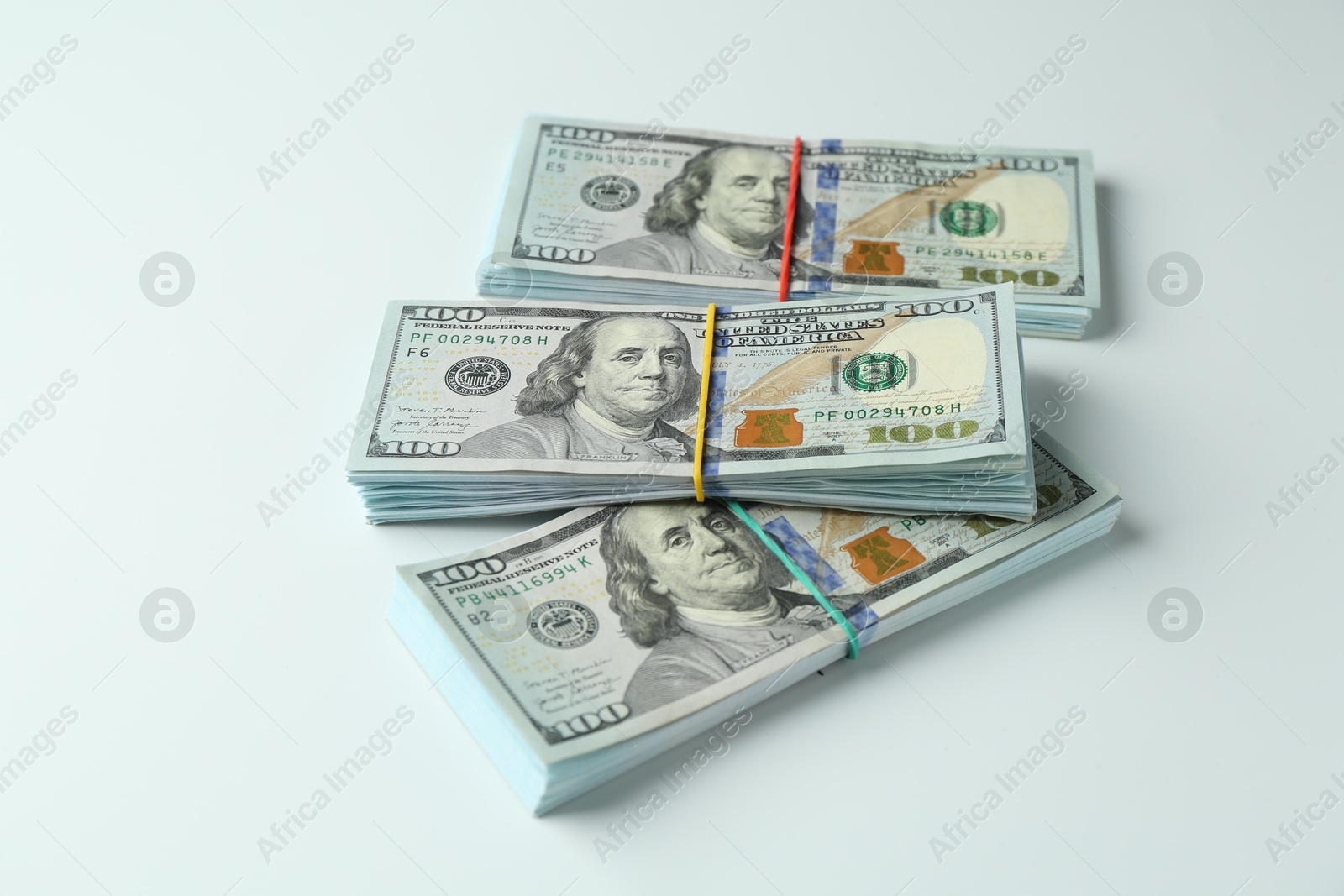 Photo of Bundles of dollar banknotes on white background