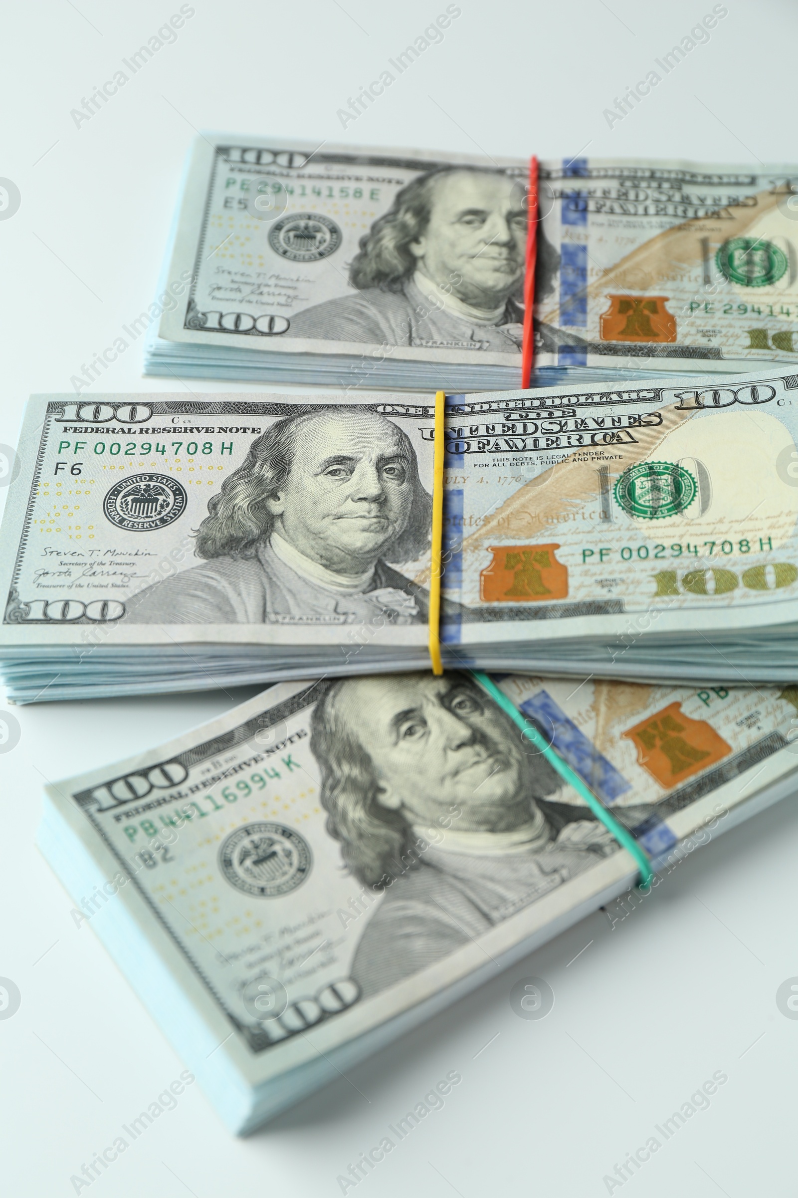 Photo of Bundles of dollar banknotes on white background