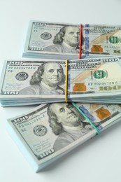 Photo of Bundles of dollar banknotes on white background