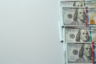 Photo of Bundles of dollar banknotes on light grey background, above view. Space for text