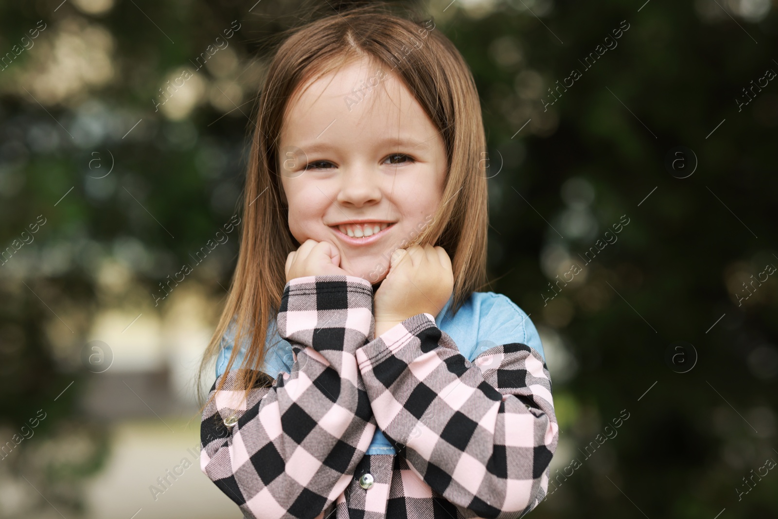 Photo of Portrait of happy little girl outdoors. Cute child