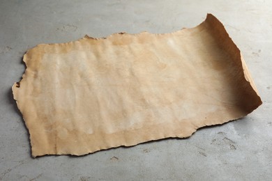 Photo of Sheet of old parchment paper on grey table