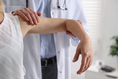 Photo of Sports injury. Doctor examining patient in hospital, closeup