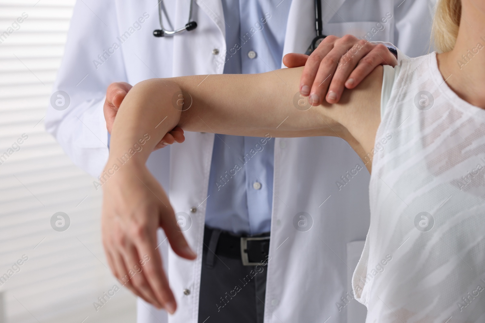 Photo of Sports injury. Doctor examining patient in hospital, closeup