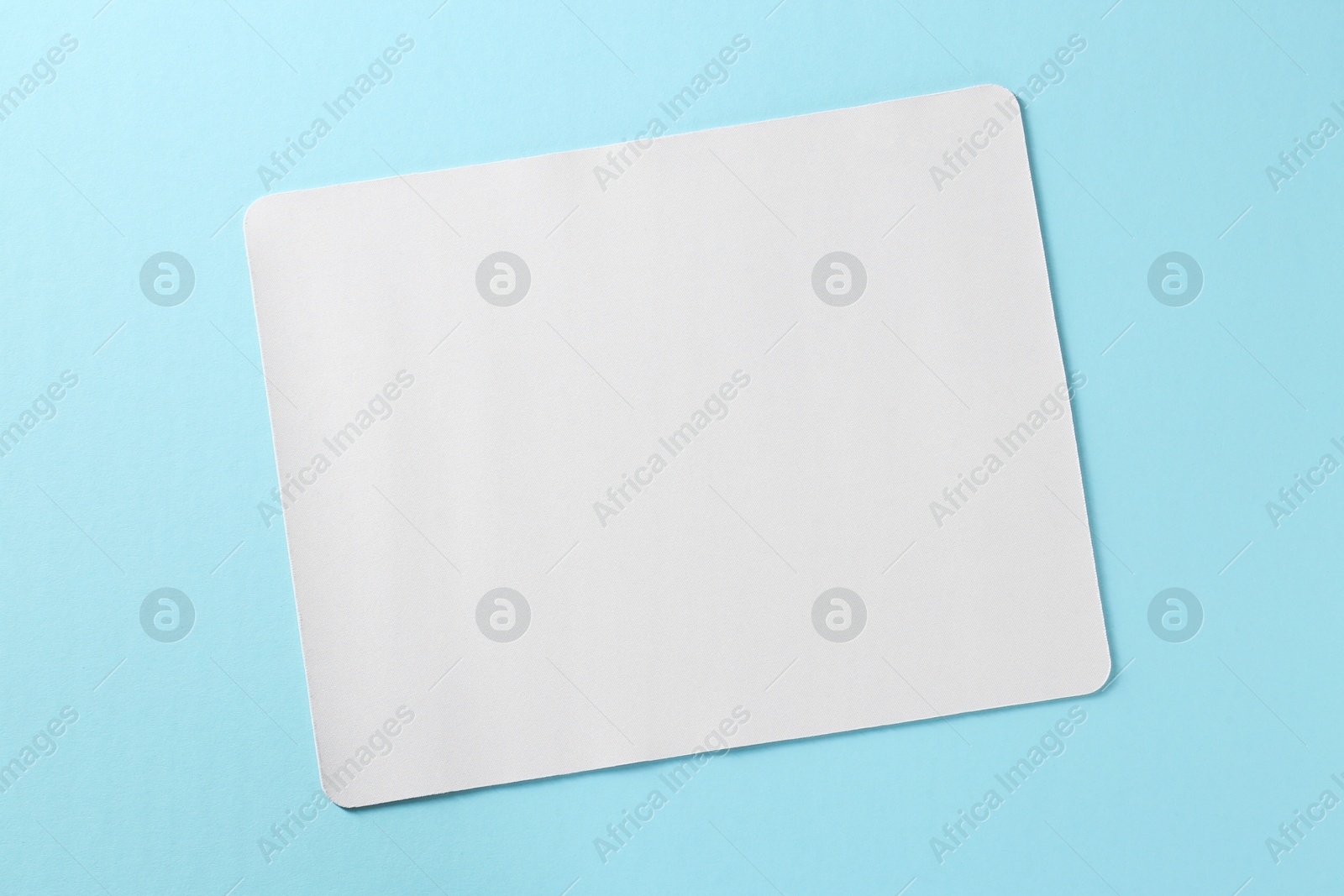 Photo of One mouse pad on light blue background, top view